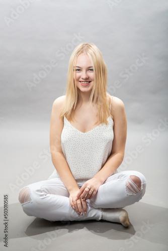 A young girl sits and laughs