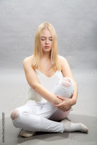 A young girl sits thoughtfully