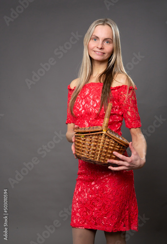 A woman holds a small basket in her hands
