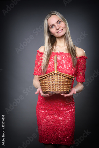 A woman holds a small basket in her hands