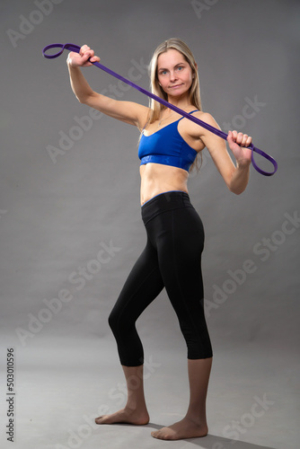 A woman holds a gymnastic cord in her hands