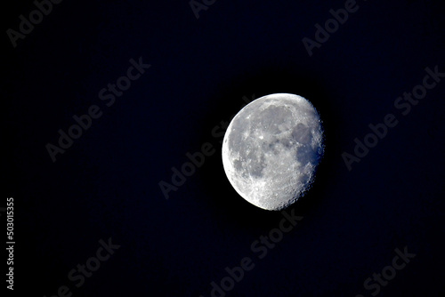 Waining Gibbous Moon against black sky photo