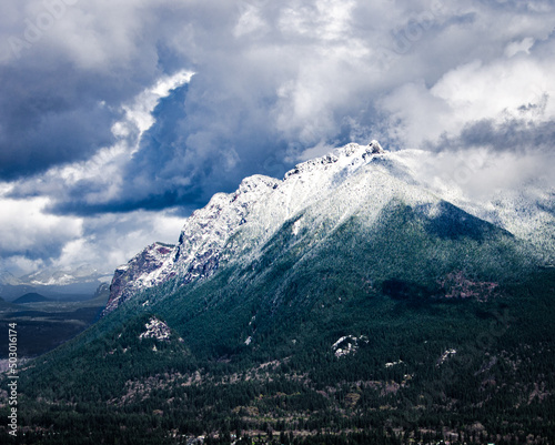 Snow-capped Mount Si in western Washington with dramatic stormy skies overhead 