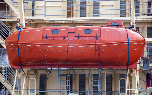 Фотография An orange closed-type Arctic lifeboat on board an icebreaker.