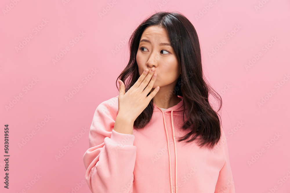 Adorable lovely Asian student young lady in pink hoodie sweatshirt sends kiss to you posing isolated on over pink studio background. Good offer. Fashion New Collection concept. Copy space Adorable lovely Asian student young lady in pink hoodie sweatshirt sends kiss to you posing isolated on over pink studio background. Good offer. Fashion New Collection concept. Copy space