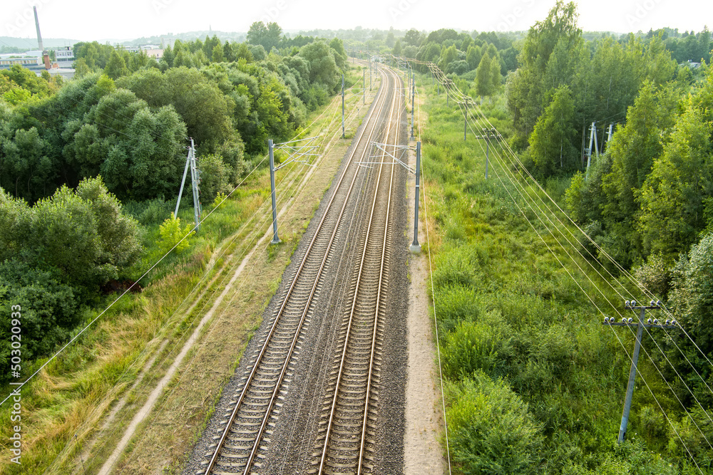 Beautiful top down aerial view of railroad tracks. Railroad tracks surrounded by green vegetation of countryside. Beautiful top down aerial view of railroad tracks. Railroad tracks surrounded by green vegetation of countryside.
