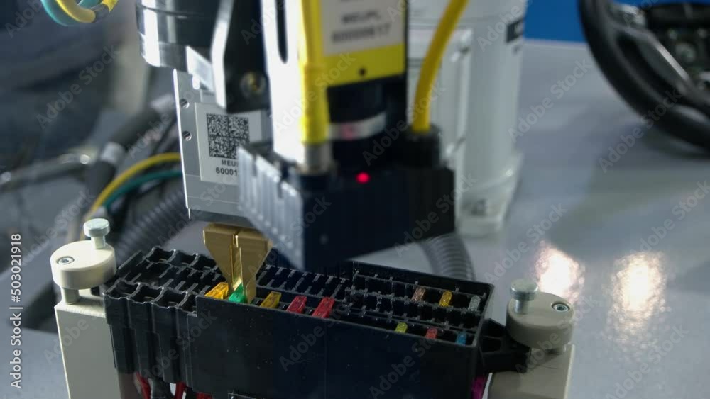 Close-up automatic manufacture robot pulling out a chip. Industrial manufacturing concept. Pull out and insert. Close-up automatic manufacture robot pulling out a chip. Industrial manufacturing concept. Pull out and insert.