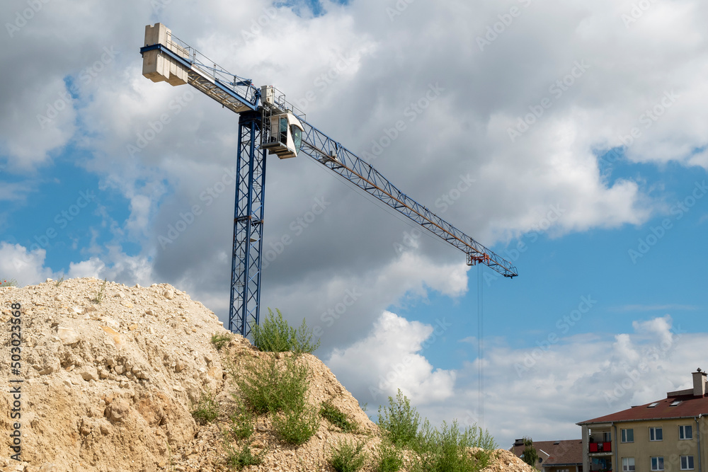 Construction site with construction crane on a sunny day Construction site with construction crane on a sunny day