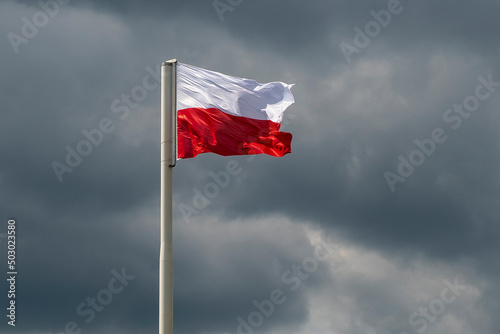National flag of Poland on the cloudy sky background