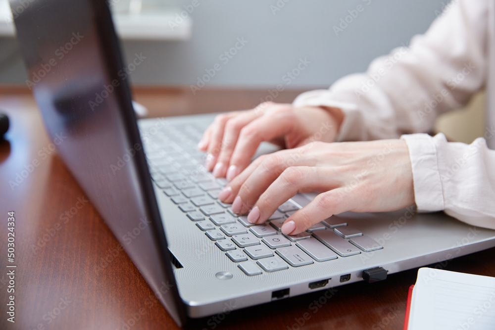 Close-up of female hands typing on the keyboard Close-up of female hands typing on the keyboard