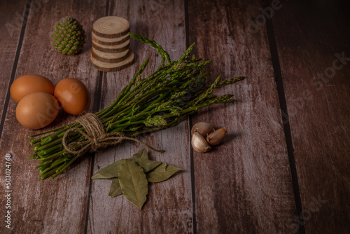 bunch of wild asparagus with ingredients for making an omelet