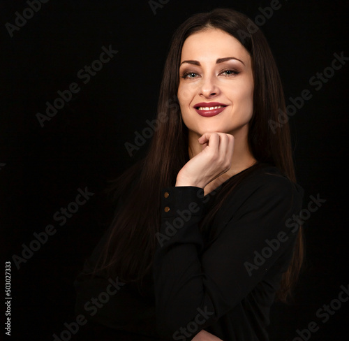 Beautiful confident happy smiling business woman with hand under the face on black background with empty copy space. Closeup portrait of natural happiness.