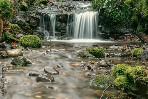 Small waterfall on a creek with cinematic effect and long exposure