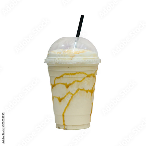 Vanilla and caramel milkshake in a transparent plastic cup and with a black straw