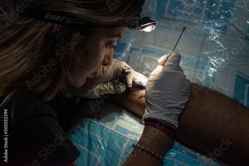 person making a handpoke tattoo