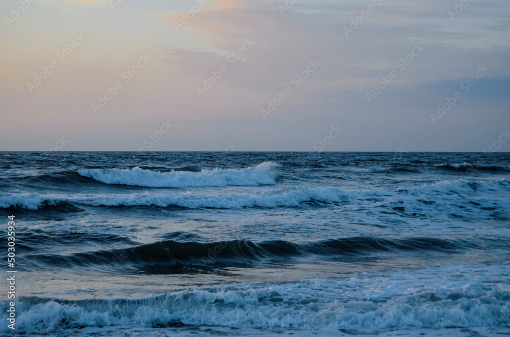 Waves washing ashore a sandy beach, Virginia Beach. 