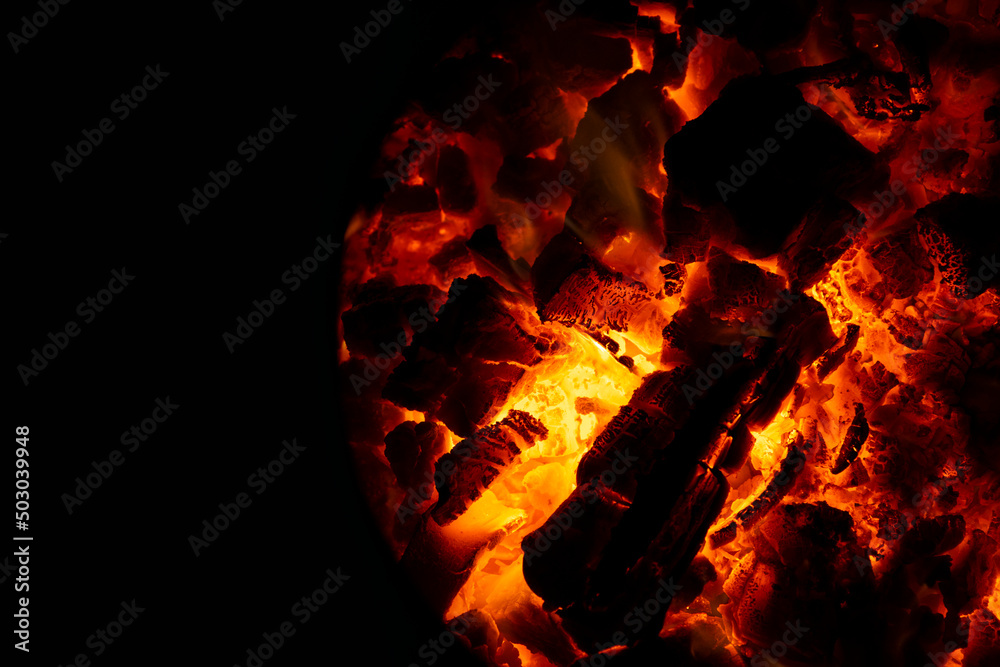 Embers in a coal furnace. Red coals from high temperature. The oven door is open. Heating the house with coal. Non-ecological fuel. Embers in a coal furnace. Red coals from high temperature. The oven door is open. Heating the house with coal. Non-ecological fuel.