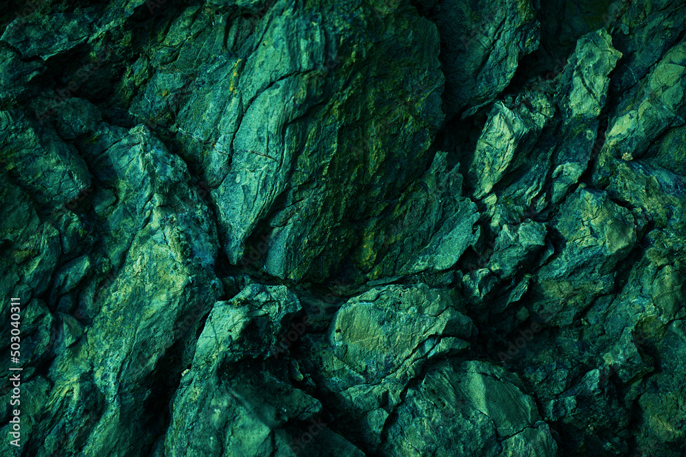Green yellow rock texture. Toned rough mountain surface texture. Crumbled. Close-up. Rocky background with space for design.
