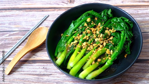 Chinese kale in oyster sauce top with fried garlic.