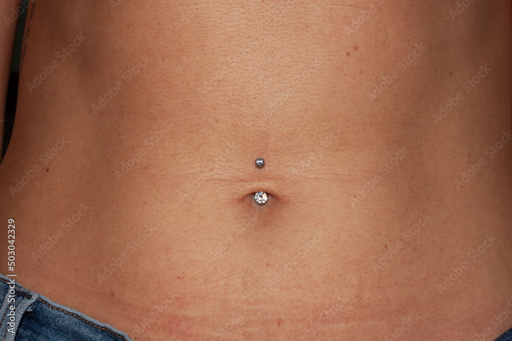 Belly button piercing. Girl's navel. Titanium piercing jewelry - banana with two transparent sparkling cubic zirkonia. Bazel-set. Belly button piercing. Girl's navel. Titanium piercing jewelry - banana with two transparent sparkling cubic zirkonia. Bazel-set.