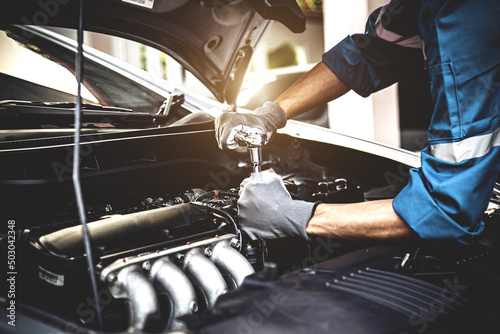 Car care maintenance and servicing, Close-up hand technician auto mechanic using the wrench to repairing change spare part car engine problem and car insurance service support.