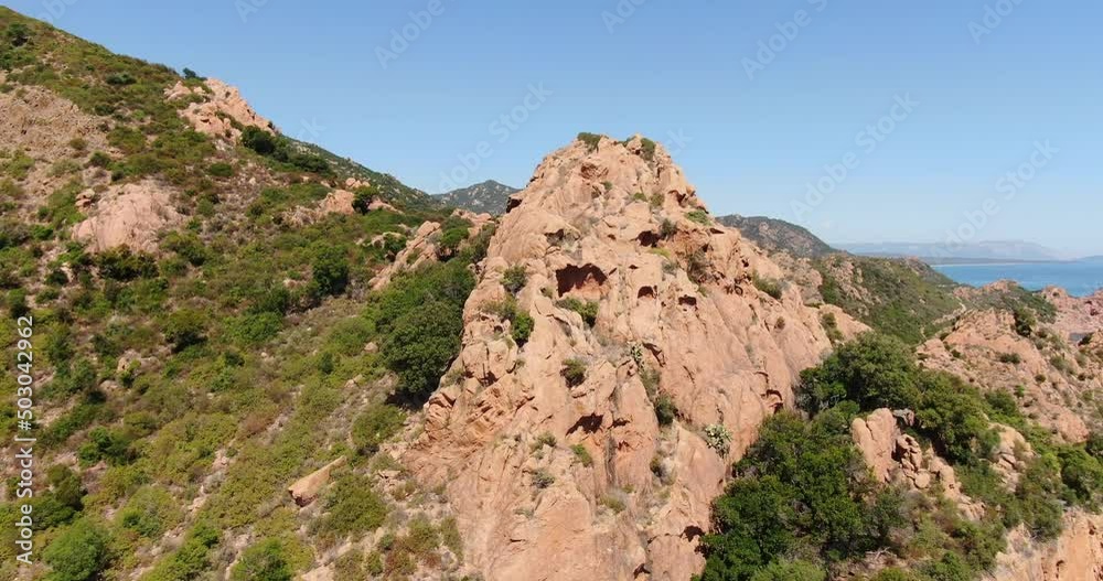 Sardinia, Italy. Aerial drone view. Flight around red rocky formations close to the sea. Sardinia, Italy. Aerial drone view. Flight around red rocky formations close to the sea.