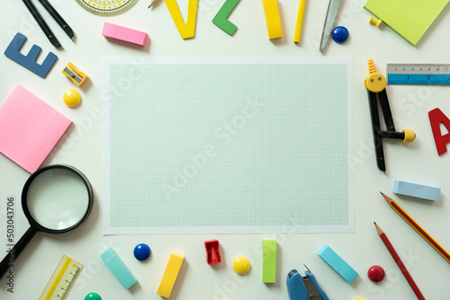 Different stationery and papar graph on white table background, flat lay. Space for text, back to school concept