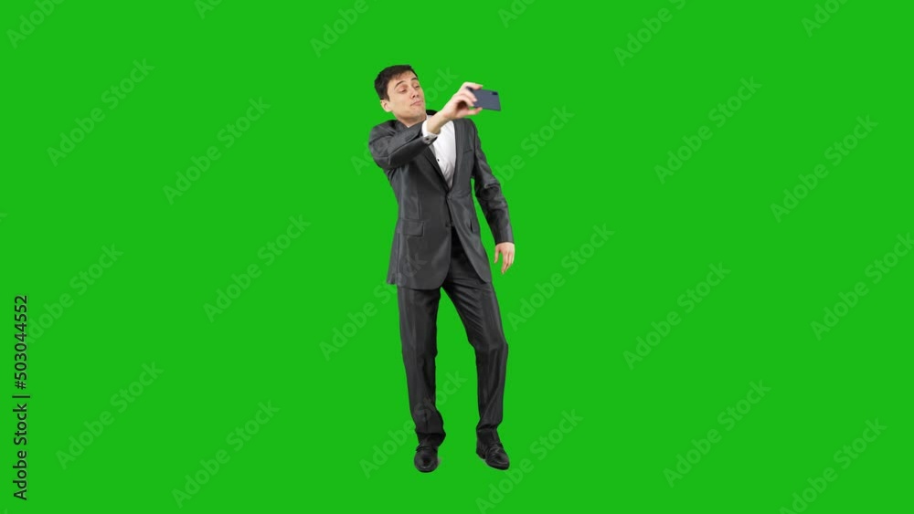 Funny businessman in suit taking selfie. Chroma key