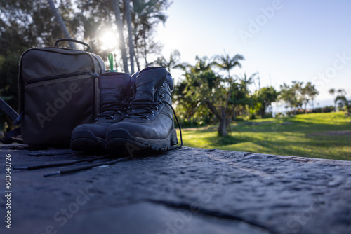 hiking boots and camera bag on tailgate with sunflare