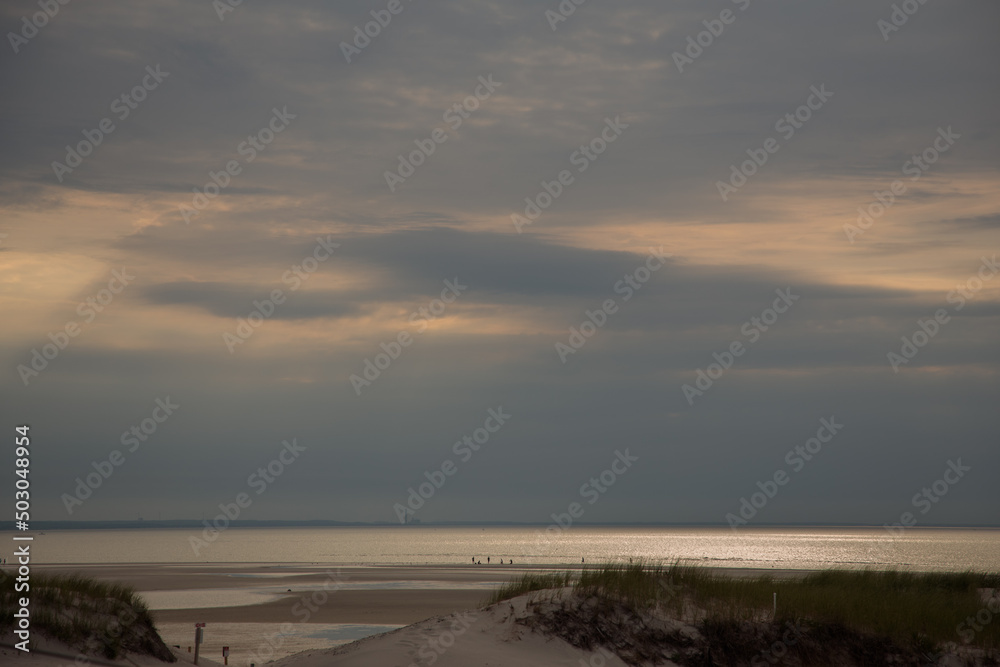 Clouds above the ocean during sunset on a beach on cape cod in massachusetts
