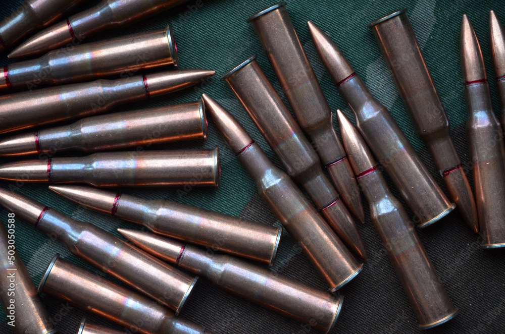 Ammunition 7,62x54 with camo background Ammunition 7,62x54 with camo background
