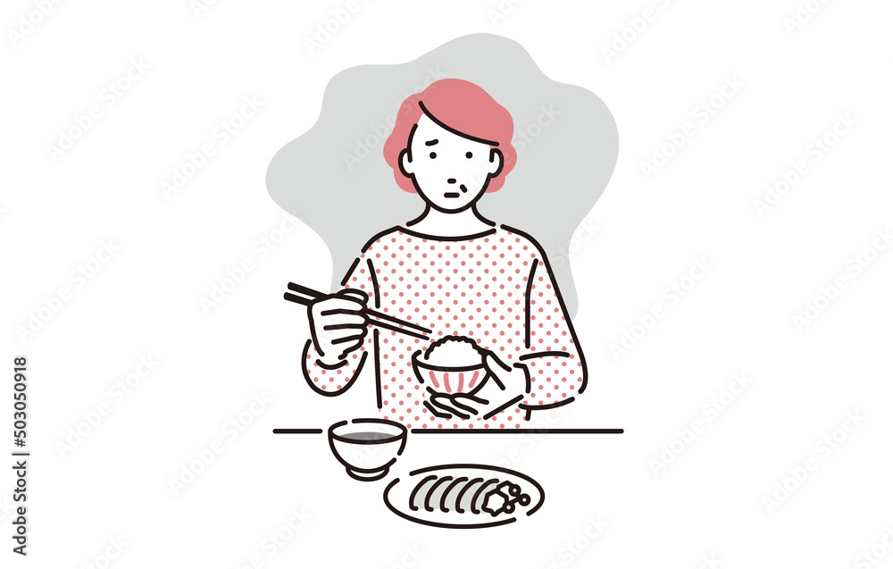 寂しい表情をうかべながら孤食するシニア女性 寂しい表情をうかべながら孤食するシニア女性