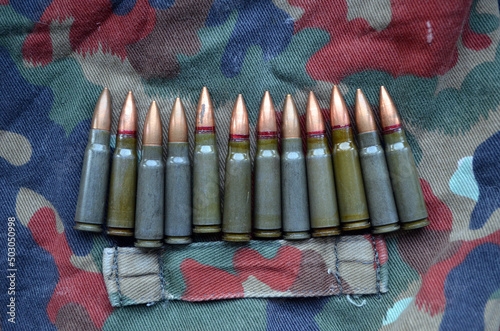 Ammunition 7,62x39 with camo background photo