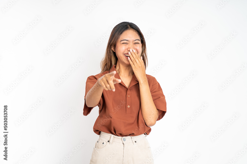 beautiful woman with finger pointing at frong and laughing at something isolated background beautiful woman with finger pointing at frong and laughing at something isolated background