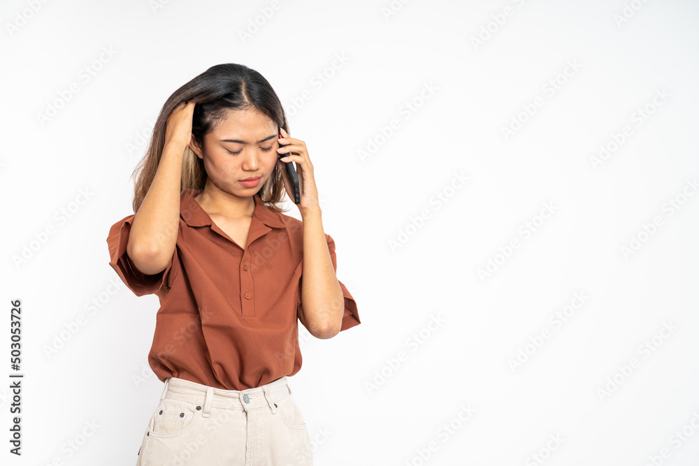 unhappy woman making a call using a smart phone when she hear bad news on isolated background unhappy woman making a call using a smart phone when she hear bad news on isolated background