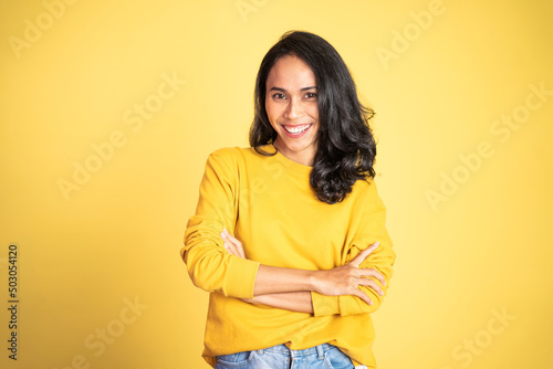 young beautiful ethnic asian woman stand with crossed hands on isolated background
