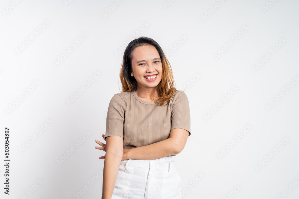 attractive asian ethnicity female looking at camera smiling with crossed arm on isolated background attractive asian ethnicity female looking at camera smiling with crossed arm on isolated background