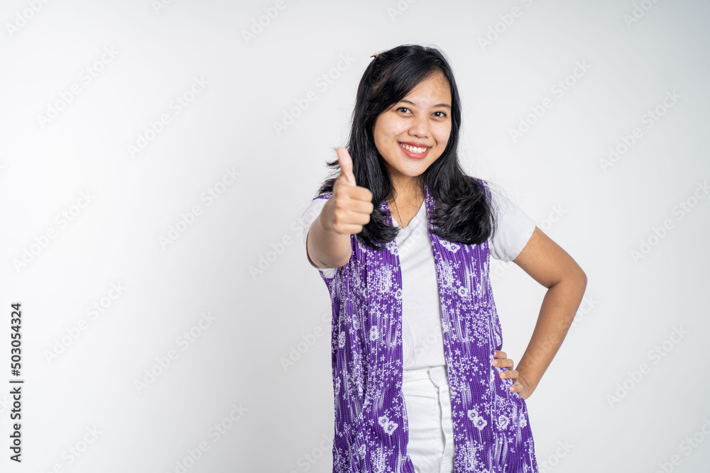 attractive smiling young woman stand with thumbs up on isolated background attractive smiling young woman stand with thumbs up on isolated background