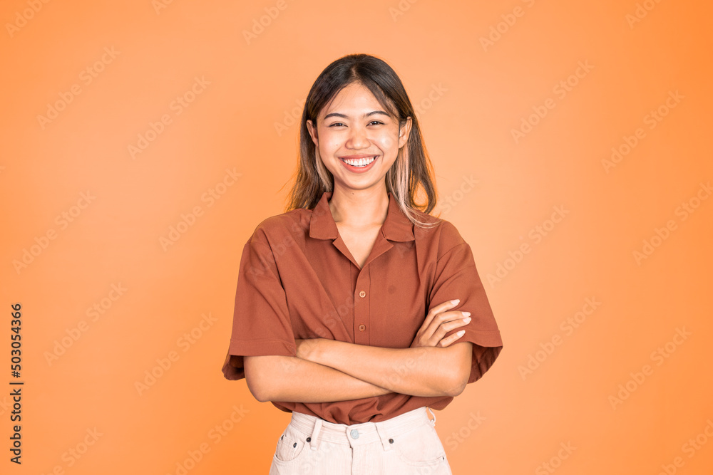 young beautiful ethnic asian woman stand with crossed hands on isolated background young beautiful ethnic asian woman stand with crossed hands on isolated background