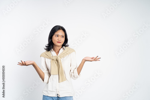 woman opening two palms does not know what to do on isolated background feeling uncertain photo
