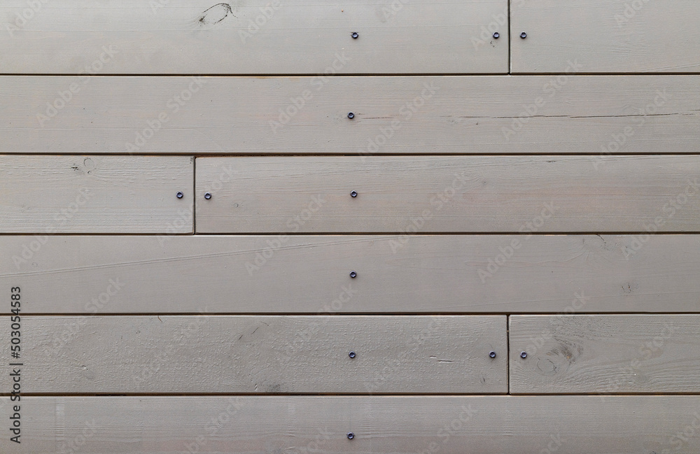 shield of gray boards fastened with roofing screws shield of gray boards fastened with roofing screws