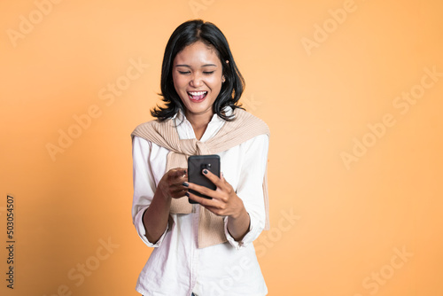 Young asian woman using smart phone typing and online browsing on social media platform