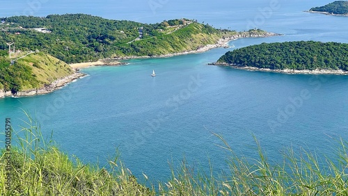 Sea and island. Beautiful view from above to the sea bay. Small tropical islands covered by green forest. Sail yacht on the surface of turquoise water. Seascape. Sailboat. Tropical paradise. Grass