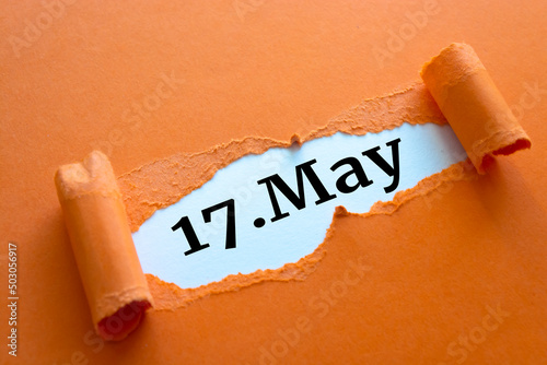 Calendar date. May 17 written under torn paper. photo