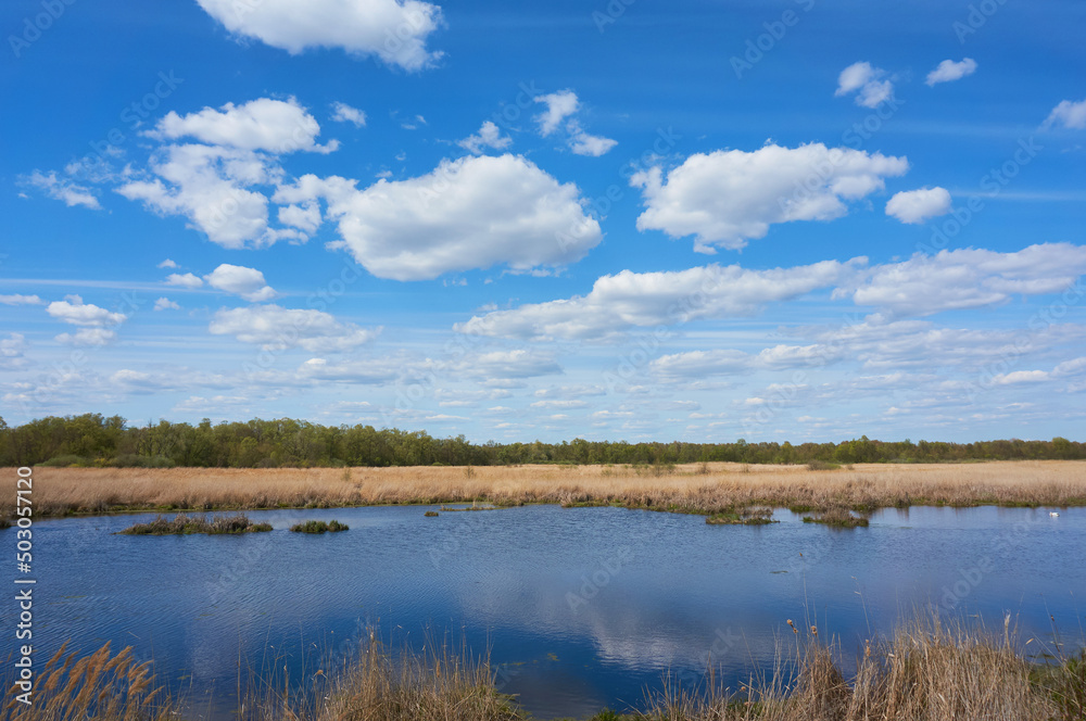 Blue, beautiful sky with cirrus clouds in the background of the lake. Nature background.