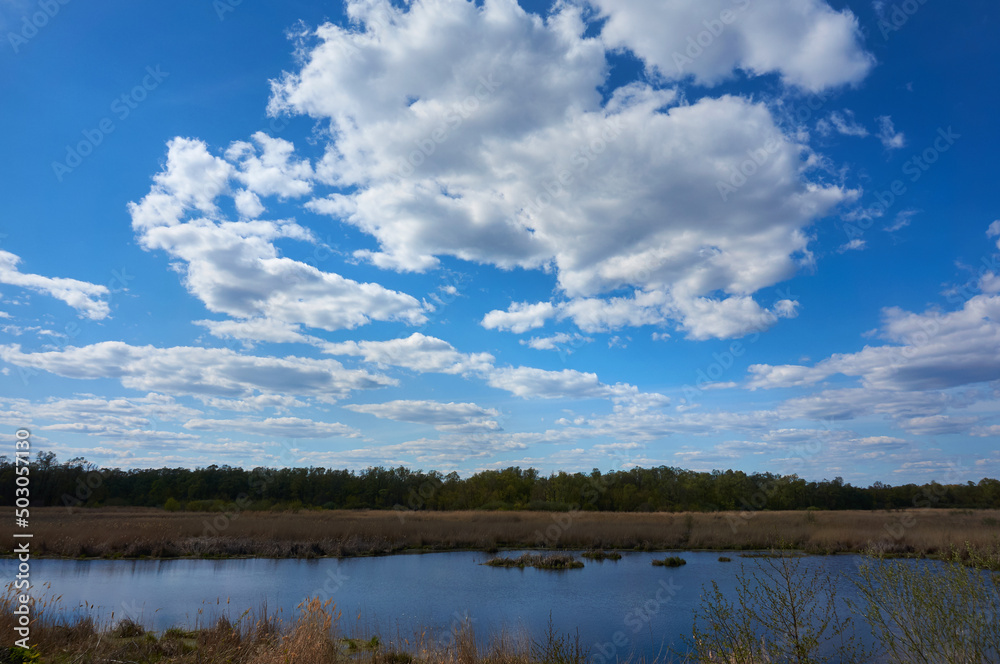 Blue, beautiful sky with cirrus clouds in the background of the lake. Nature background. Blue, beautiful sky with cirrus clouds in the background of the lake. Nature background.