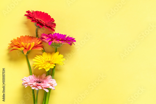 Bouquet of gerberas on yellow background Top view Flat lay Holiday greeting card Happy moter's day, 8 March, Valentine's day, Easter concept Copy space Mock up