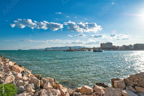 Panoramic view of the entrance to the port of Benicarló. Concrete wall and breakwater of the port. sunset in the harbor