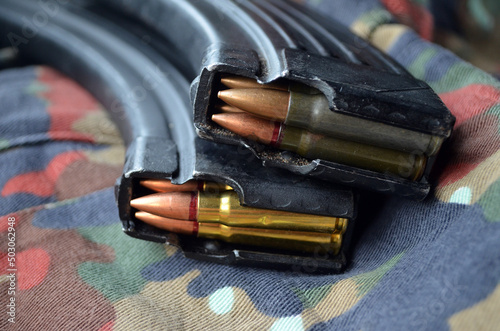 Kalashnikov assault rifle magazines 7,62x39 with camo background