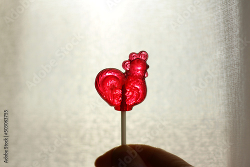 Transparent lollipop red cockerel on a stick. Fototapete